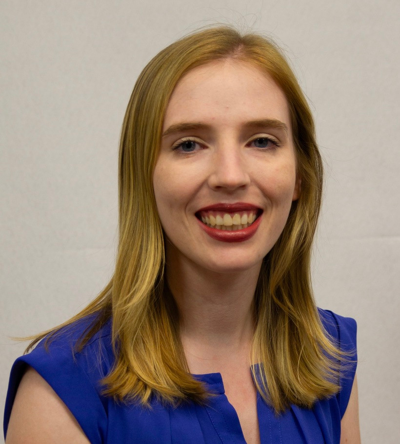 Headshot of woman in blue shirt smiling